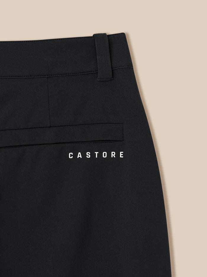 Close-up of black golf trousers waistband with belt loop and visible stitching Castore branding at the bottom edge