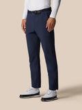 Close up of navy golf winter trousers at the waist with a black belt and white shirt