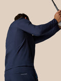 Male golfer wearing midnight navy Castore winter trousers with visible back pocket branding