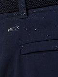 Close-up of navy golf trouser fabric with water droplets and ProTek branding.