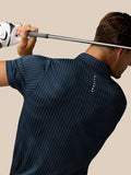 Back view of a man wearing midnight navy Golf Pinnacle Glow Polo with Castore branding along the back.