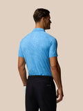 Back view of a male model wearing Golf Club Glow Printed Polo in blue with a subtle pattern.