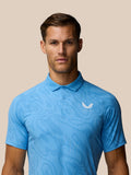 Close up of Golf Club Glow Printed Polo in blue showing a white Castore logo on the chest.