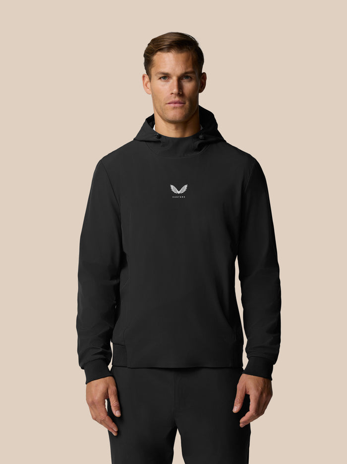 Front view of a man in a black hoodie with a small Castore logo centered on the chest