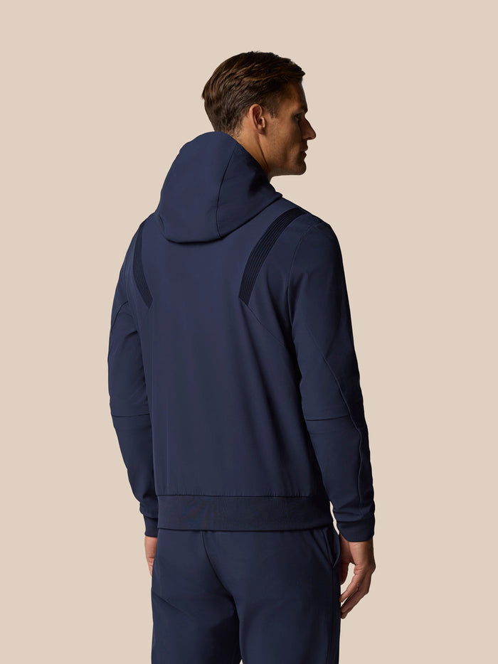 Back view of a man wearing Midnight Navy Golf Pinnacle Performance Hoodie showing hood and panel details