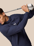 Athlete in a navy Golf Pinnacle Performance Hoodie swinging a golf club with Castore logo visible on the chest