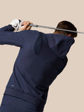 Back view of golfer in navy Golf Pinnacle Performance Hoodie during a swing with Castore logo on the chest