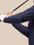 Close up of a golfer in a midnight navy Pinnacle Performance Hoodie gripping a golf club