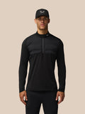 Male model wearing black LVS hybrid golf top with padded chest panels and a half-zip
