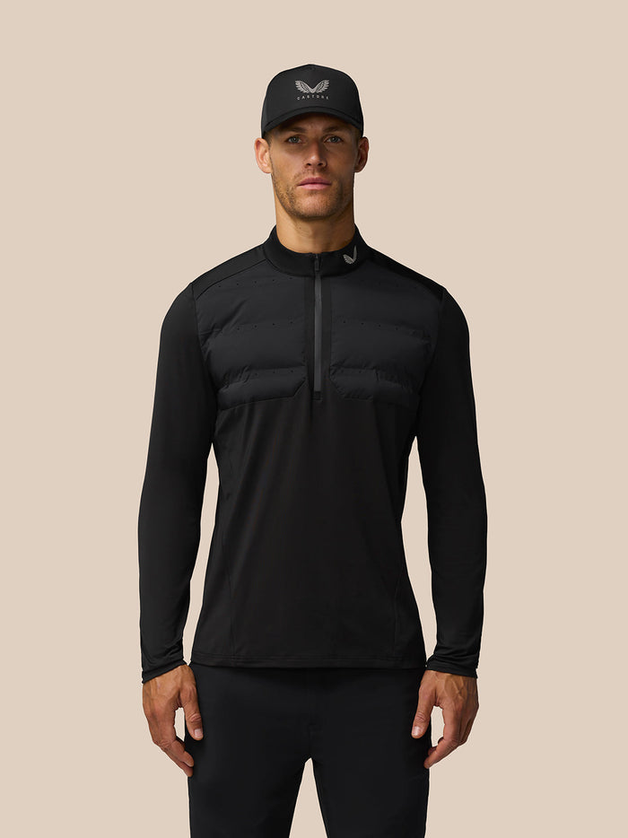 Male model wearing black LVS hybrid golf top with padded chest panels and a half-zip