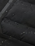 Close-up of water droplets on black jacket fabric with a visible zipper and seam.