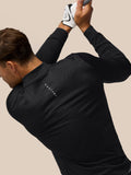 Golfer in a black Castore golf top with a subtle linear pattern and visible Castore branding on the back