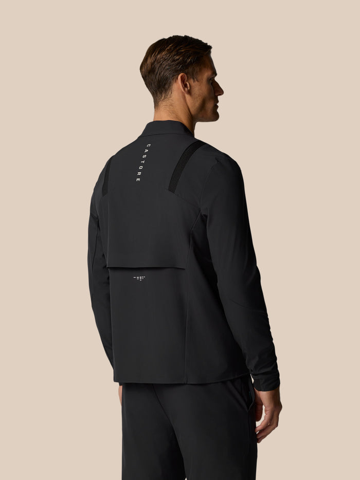 Back view of a man in black LVS Winter Jacket showing shoulder panels and vertical CASTORE branding along the back