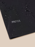 Close-up of black LVS Golf jacket fabric with water droplets and ProTek branding