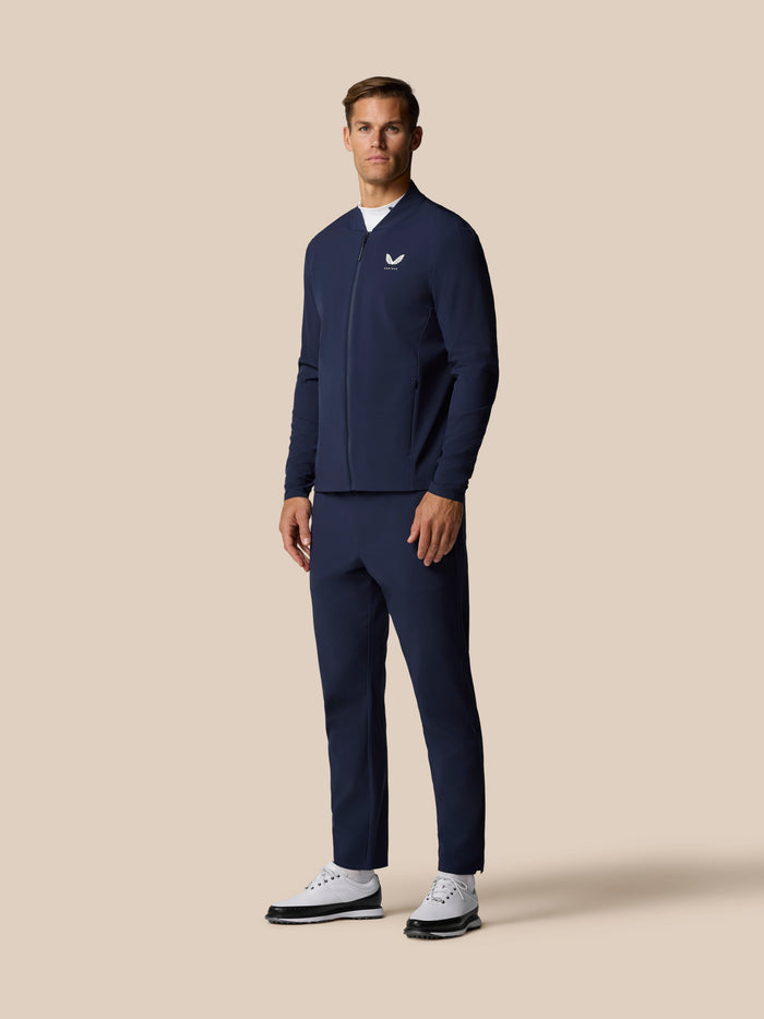Male model wearing midnight navy Golf Pinnacle LVS Winter Jacket with front zip and left chest logo