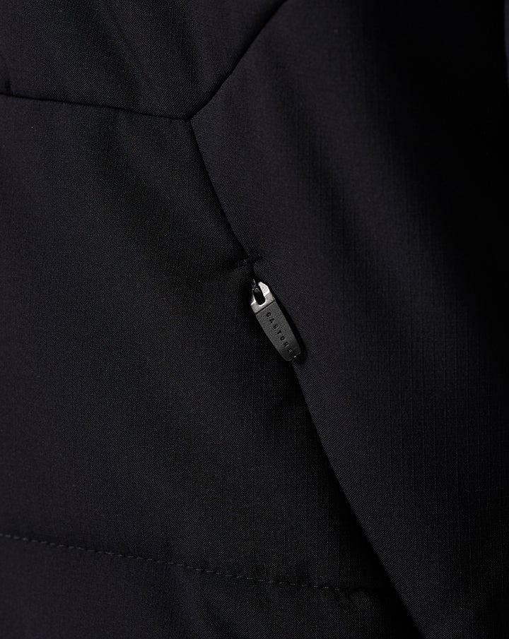 Close up of black Saracens training padded jacket showing zipper pull and textured fabric