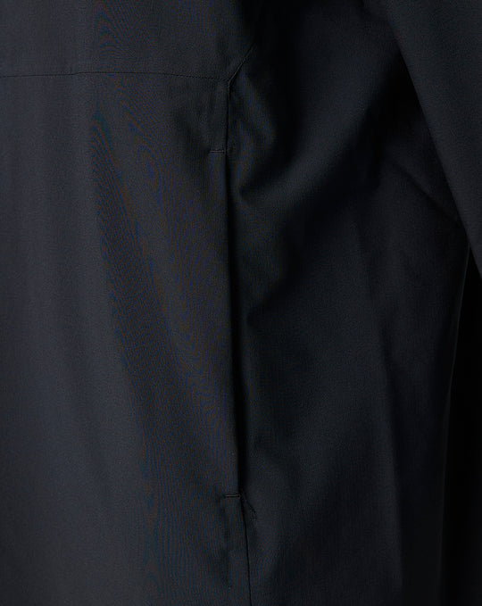 Close up of black fabric from the Saracens training robe showing a side seam and neat stitching.