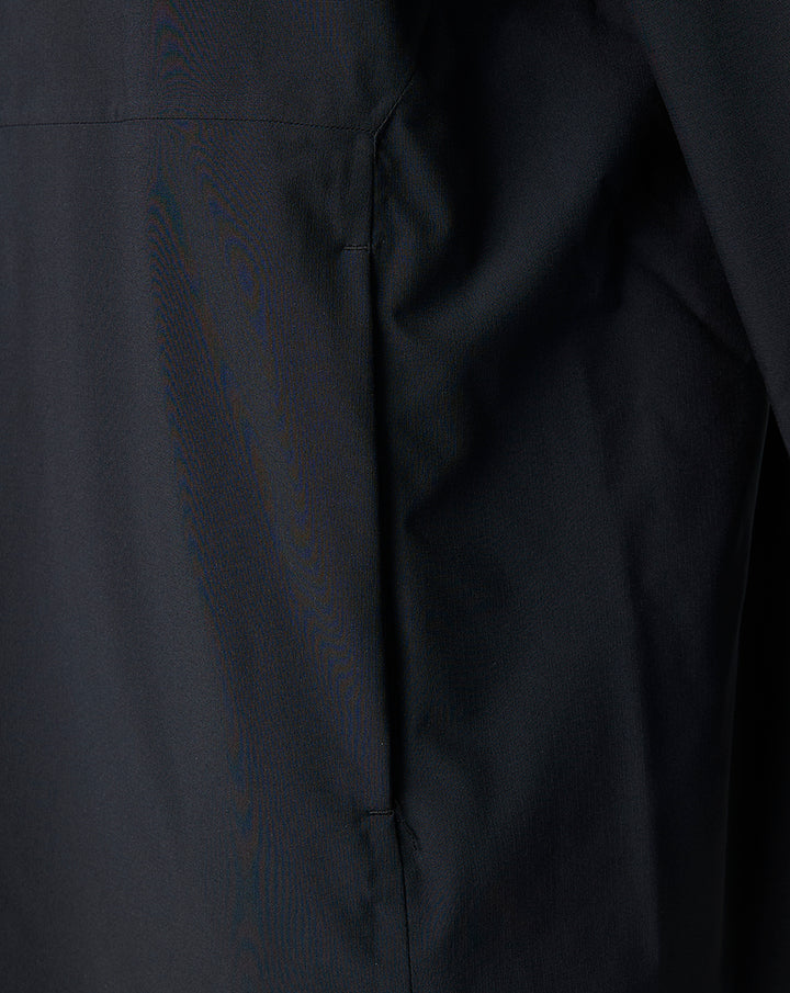 Close up of black fabric from the Saracens training robe showing a side seam and neat stitching.