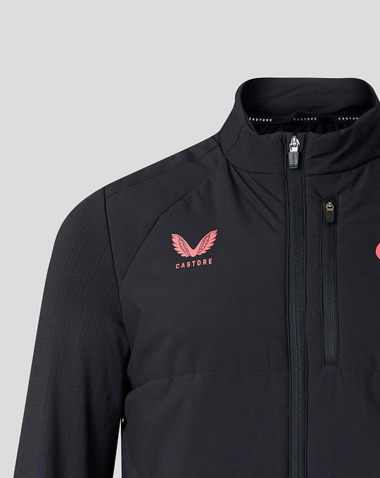 Close-up of chest area on black training jacket showing pink Castore crest and zipper detail