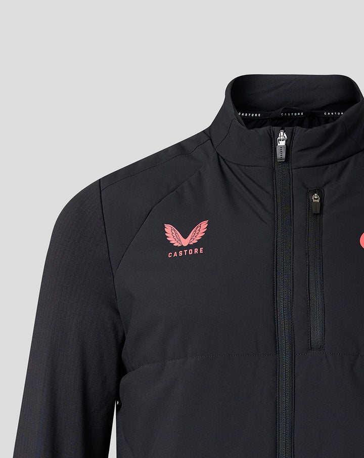 Close-up of chest area on black training jacket showing pink Castore crest and zipper detail