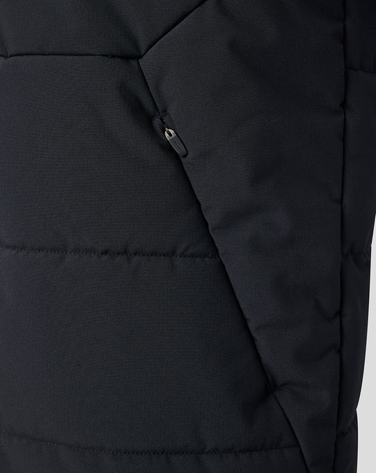 Close up of black padded Saracens training gilet with zip pocket and stand collar.