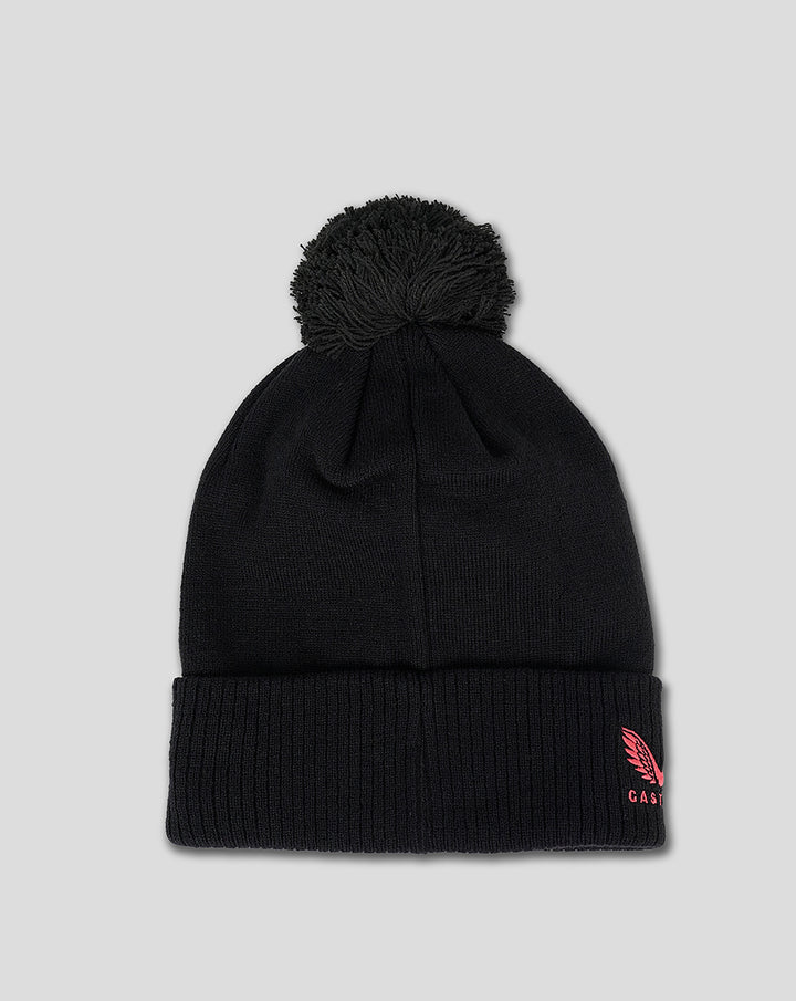 Front view of black bobble beanie with pom pom on top and pink crescent moon emblem on the cuff