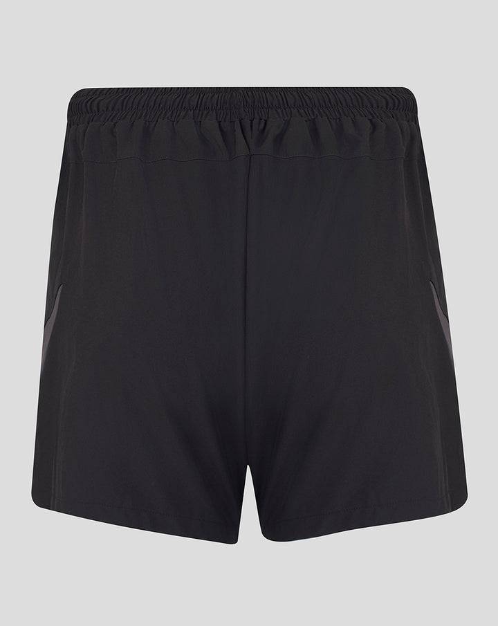 Back view of black Saracens training shorts with elastic waistband and pink crescent and star emblem and Castore branding.