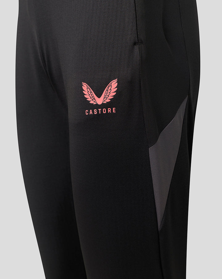 Close up of black Saracens 2026/27 training pants with pink Castore crest on the thigh and a zipped pocket.
