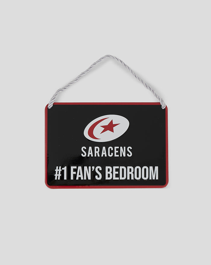 Black sign with white crescent and red star logo and SARACENS #1 FAN'S BEDROOM hanging by a rope