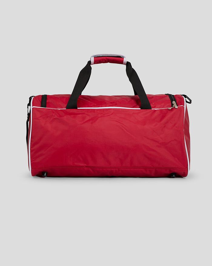 Red Club Holdall shown from the side with black handles detachable strap and white piping along edges
