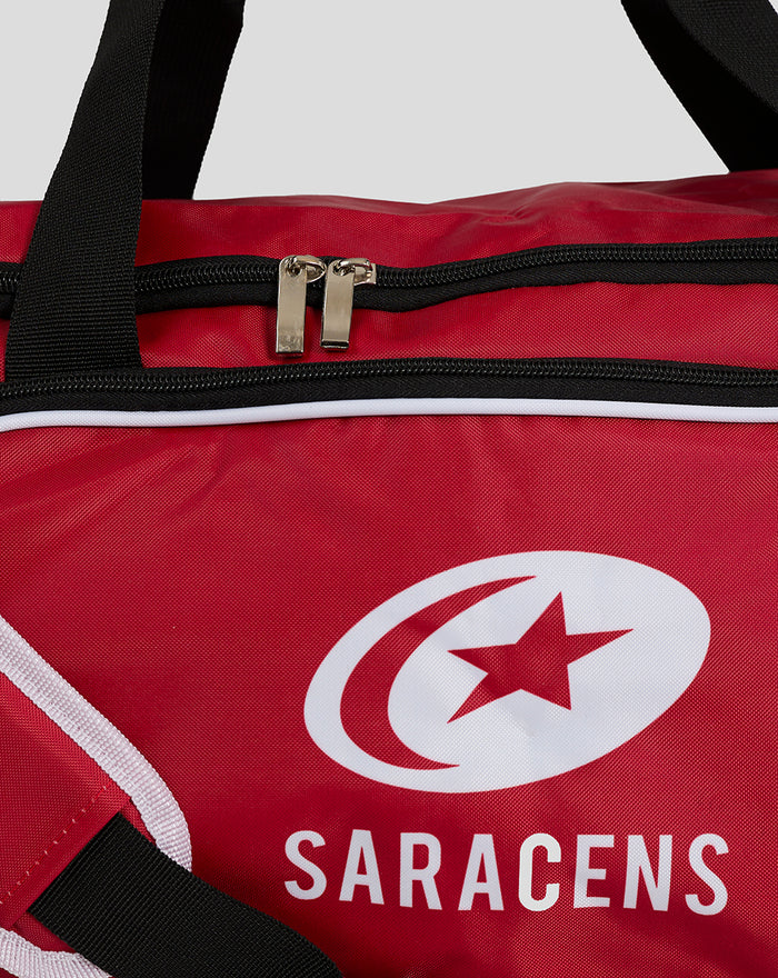 Red holdall with black straps and dual zipper pulls featuring Saracens branding.