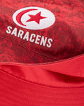 SARACENS crest embroidered on red camouflage bucket hat in close up