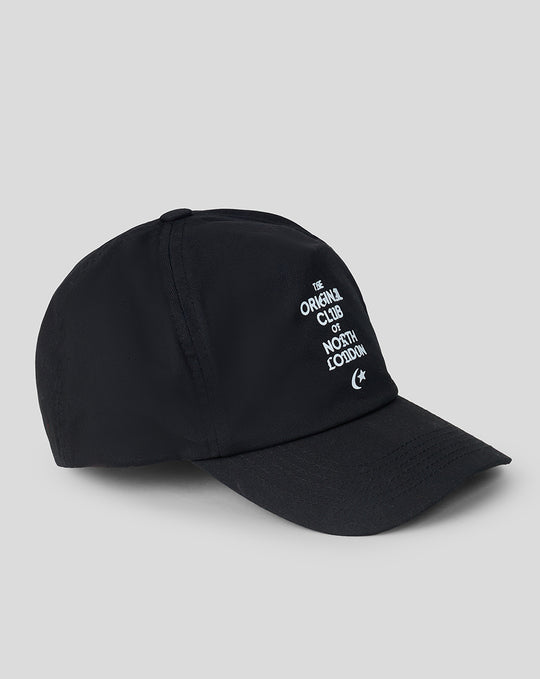 Black cap viewed from the side with white embroidery on the front panel that says The Original Club of North London.