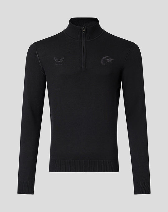 Front view of black knit quarter zip top with a high collar and tonal Saracens crest embroidery