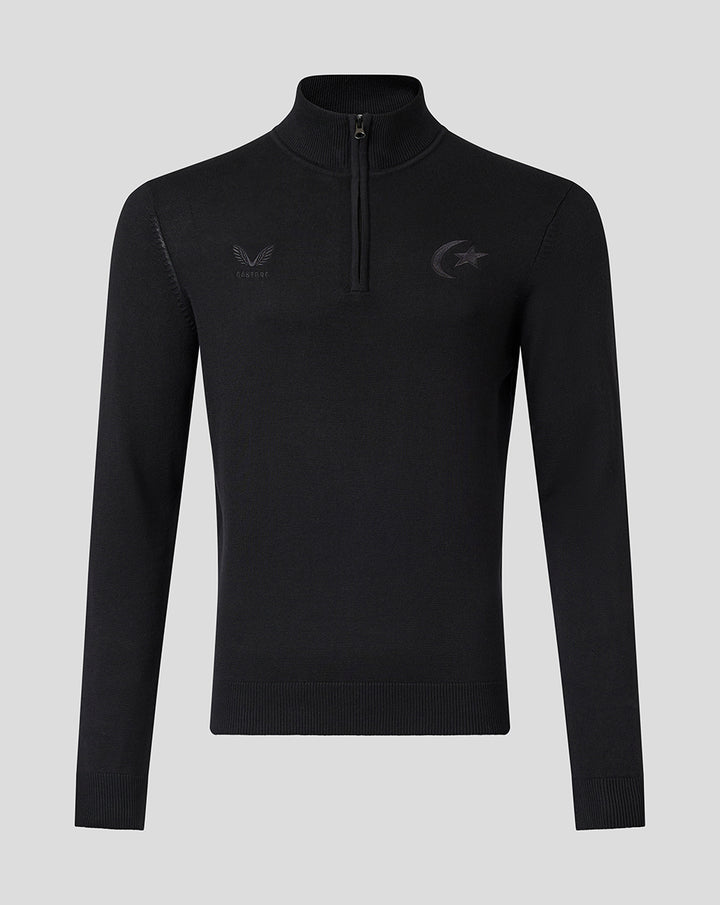 Front view of black knit quarter zip top with a high collar and tonal Saracens crest embroidery