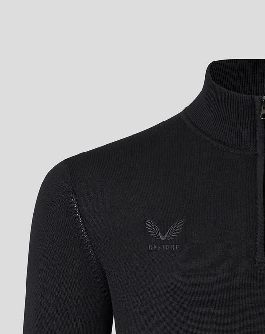 Close up of a black knit Saracens quarter zip with a high collar and a tonal crest on the chest.