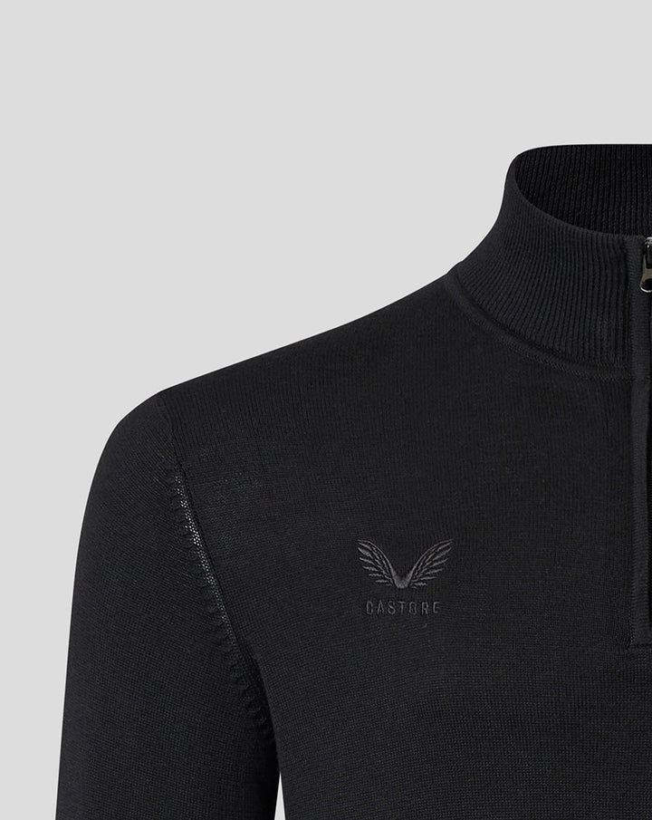 Close up of a black knit Saracens quarter zip with a high collar and a tonal crest on the chest.