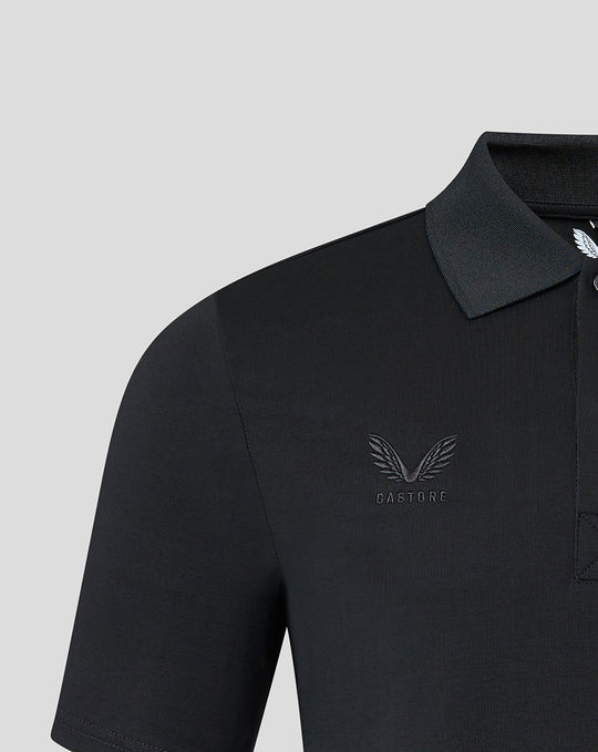 Close up of black polo showing tonal Saracens crest and Castore branding on the chest