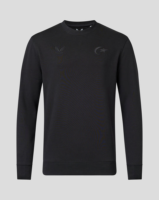 Front view of black crew neck sweatshirt with tonal Saracens crest and Castore branding and ribbed cuffs.