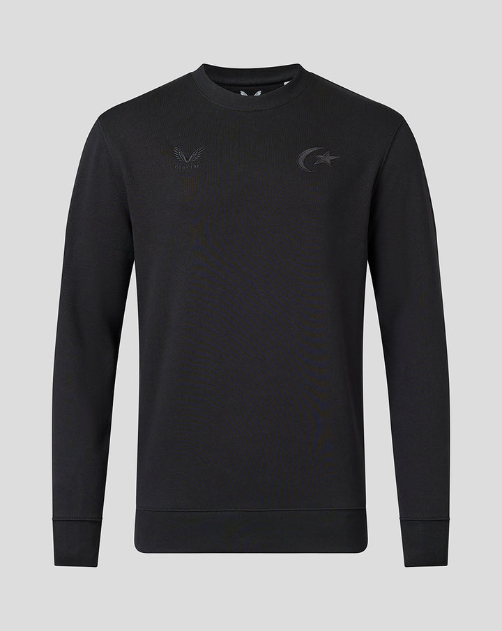 Front view of black crew neck sweatshirt with tonal Saracens crest and Castore branding and ribbed cuffs.