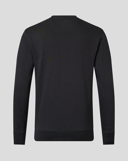 Close up of upper chest on black crew neck sweatshirt showing tonal Saracens crest and Castore branding.