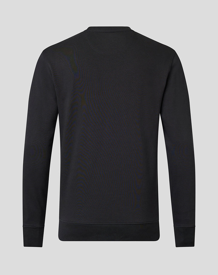 Close up of upper chest on black crew neck sweatshirt showing tonal Saracens crest and Castore branding.