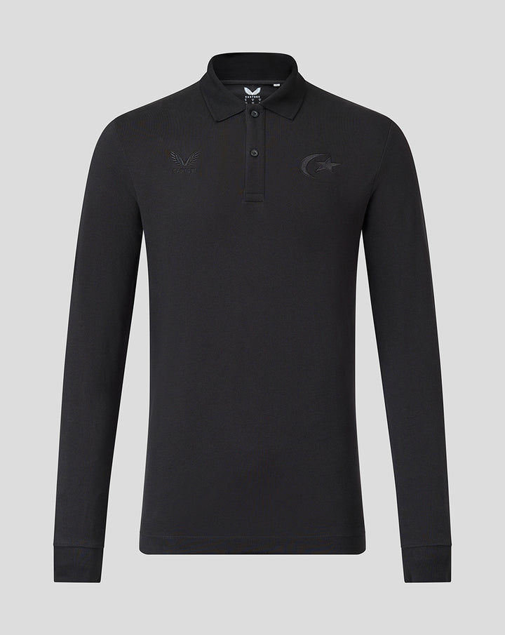 Front view of black long sleeve polo with tonal Saracens crest and Castore branding, classic polo collar and two-button placket.
