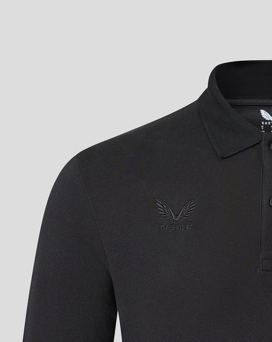 Close-up of left chest showing tonal Saracens crest and Castore branding embroidery on black polo.