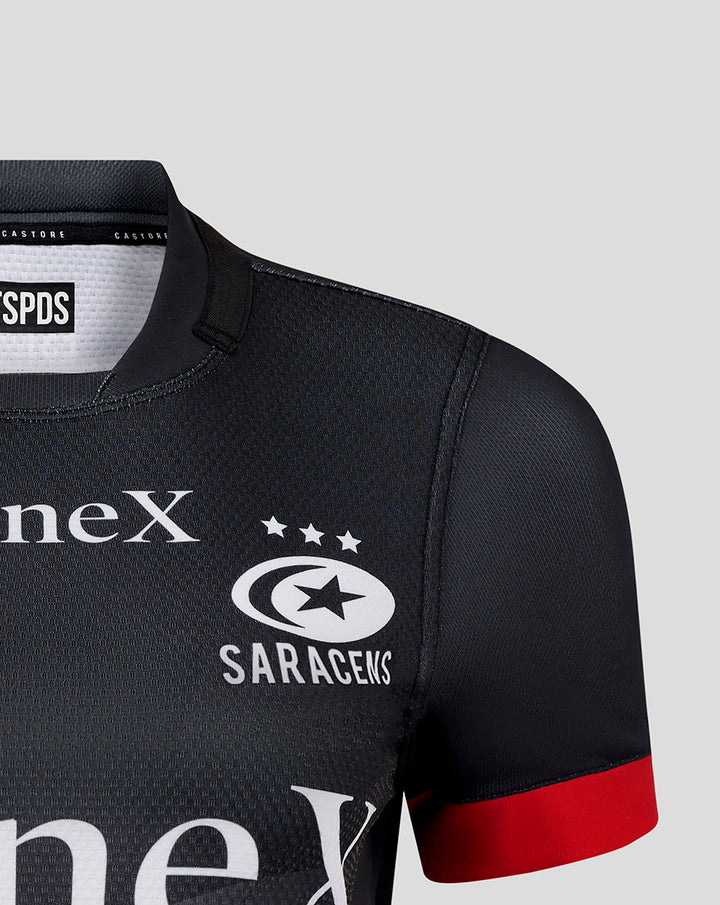 Close-up of upper chest on black Pro Home Shirt showing StoneX and Saracens crest