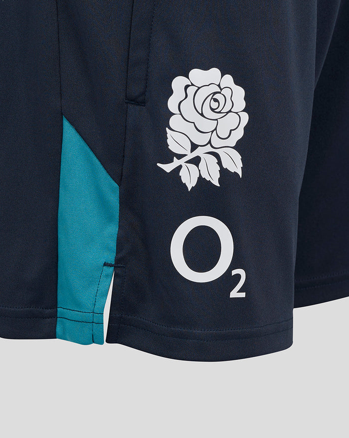 Close-up of navy shorts showing the white rose crest and O2 logo with teal side panel