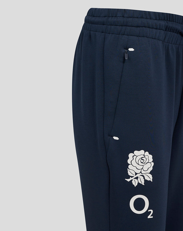 Women's England Rugby Travel Knit Pant in navy with zip pockets drawcords and rose O2 logo on the leg.