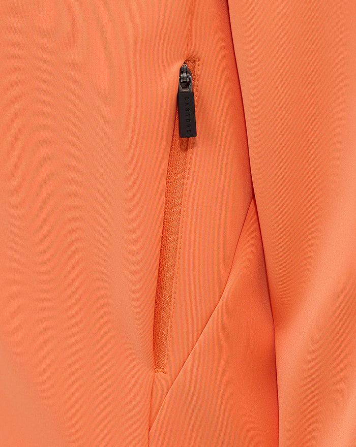 Close-up of orange hoodie zipper with CASTORE branding on the pull