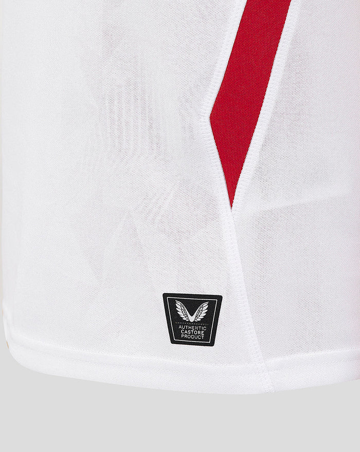 Close-up of white England Rugby Home Pro Shirt front showing a red angled stripe and a Castore authentication patch at the hem