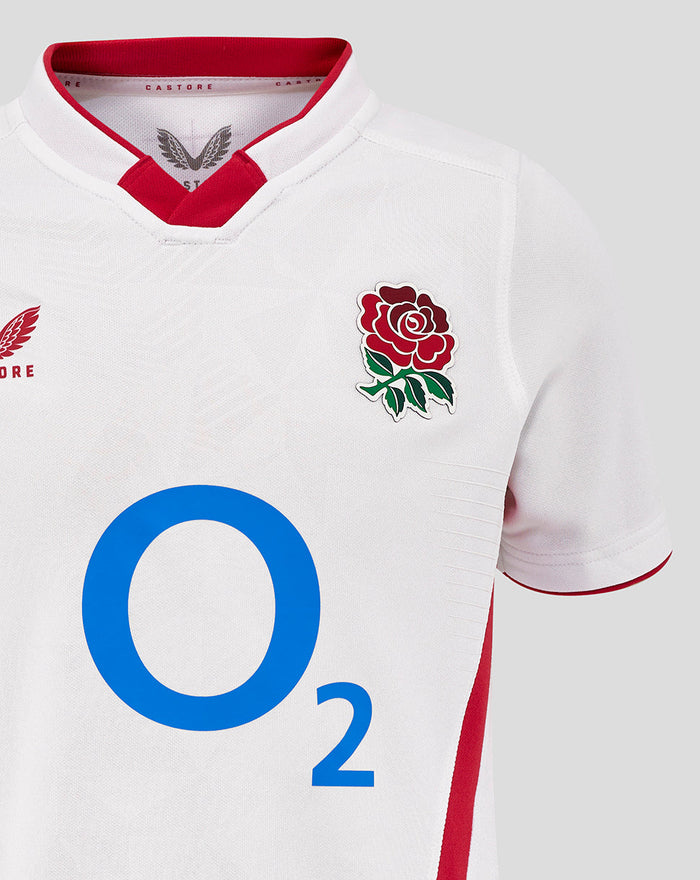 Close-up of chest area on white Junior England Rugby Home Pro Shirt showing rose crest on right chest, Castore branding on left chest and large central O2 logo